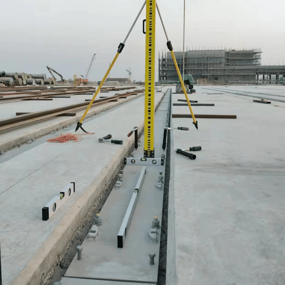 Crane rail sole plate installed under a rail with clips on a crane runway