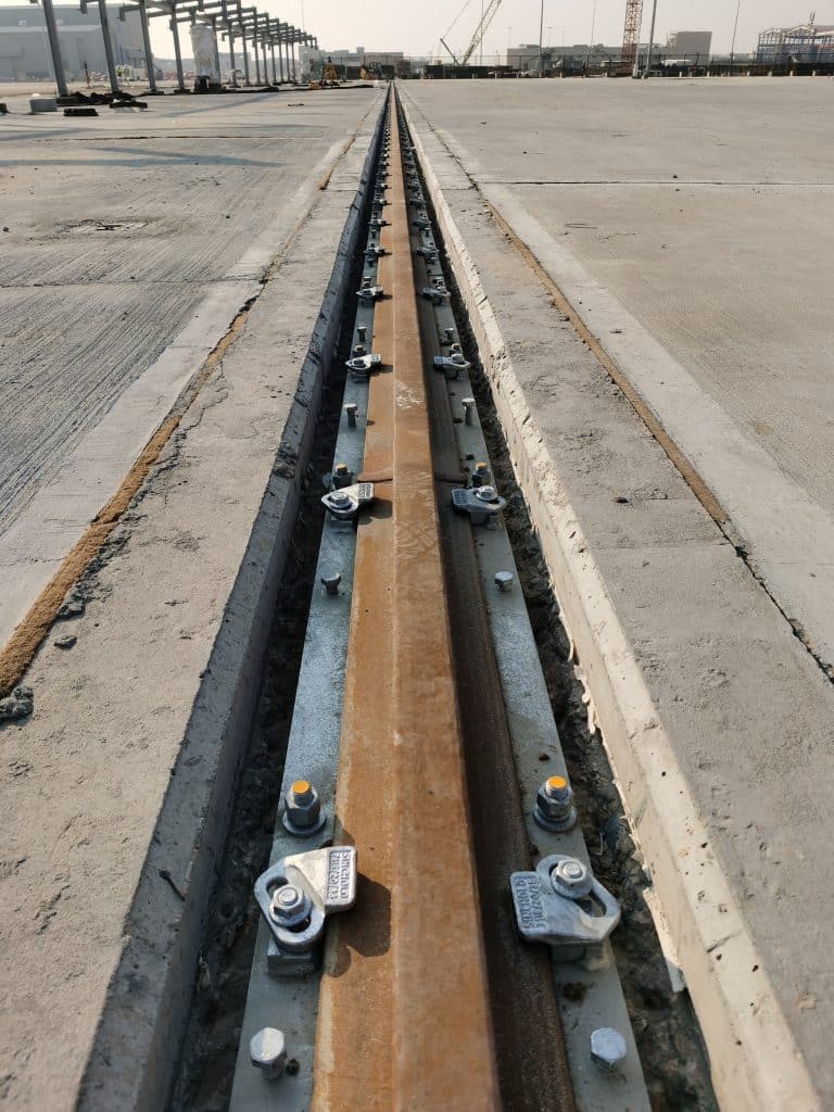 Completed crane rail installation with proper alignment and forged rail clips