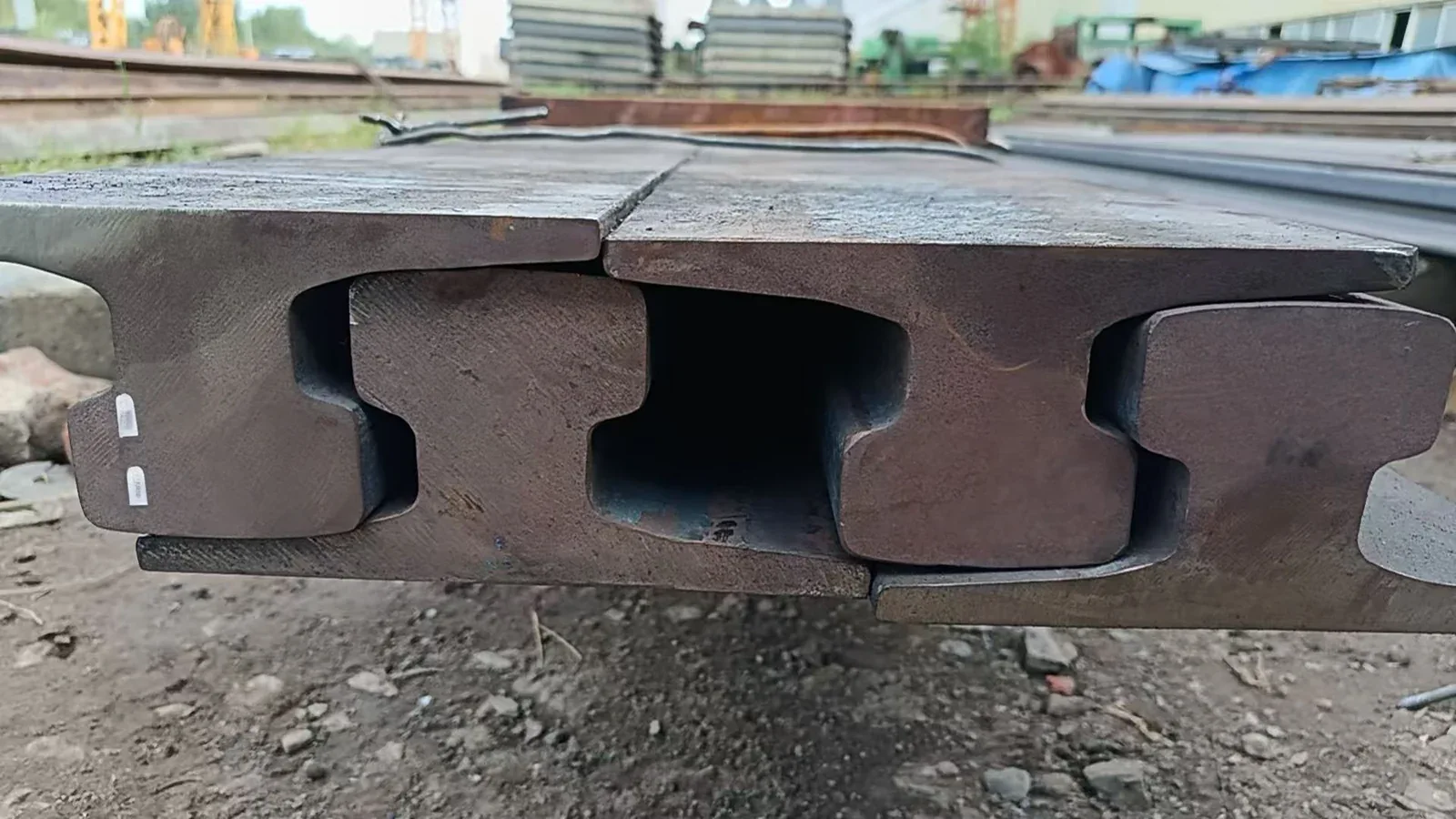 Heavy crane rail sections stacked in the workshop