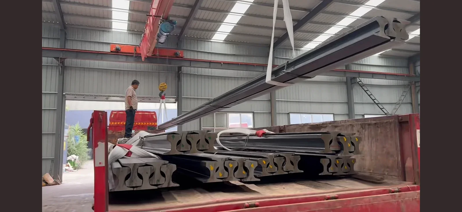 Crane rail bundles being loaded for shipment